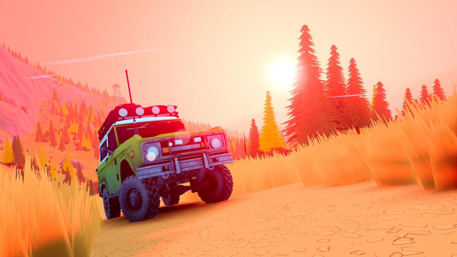 A green vintage 4x4 driving down a dry dirt road at sunset